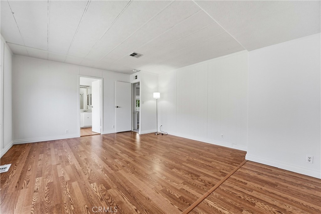 4901 Green River Road, Unit 140 Corona, CA 92878 - Photo 10 of 21 a view of an empty room and wooden floor