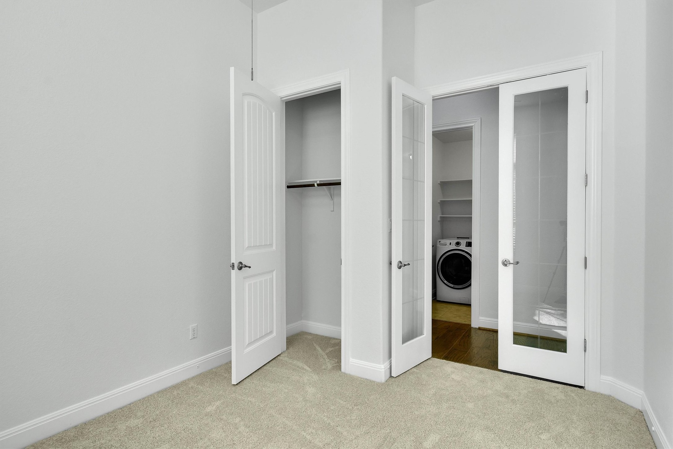 2325 Blended Tree Ranch Drive Leander, TX 78641 - Photo 21 of 35 Comfortable bedroom with neutral carpeting, an organized closet, and a conveniently located laundry area.