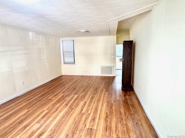 45-47 43rd Street Queens, NY 11104 - Photo 3 of 26 Empty room with light wood-style flooring and healthy amount of natural light