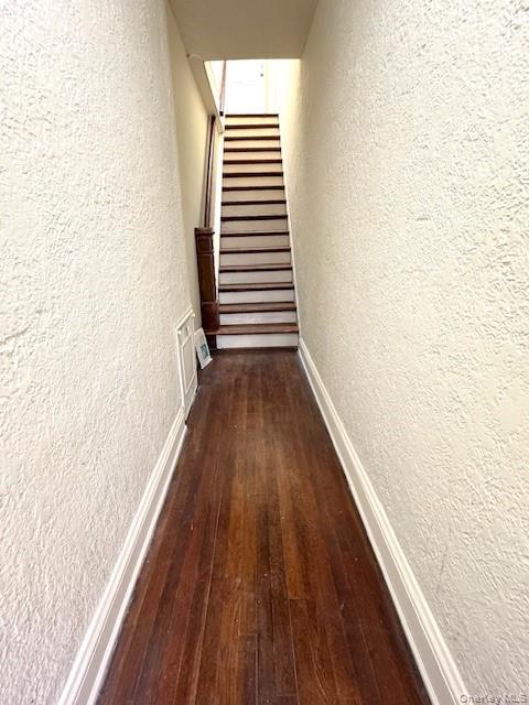 45-47 43rd Street Queens, NY 11104 - Photo 10 of 26 Hall with a textured wall, dark wood finished floors, and stairway