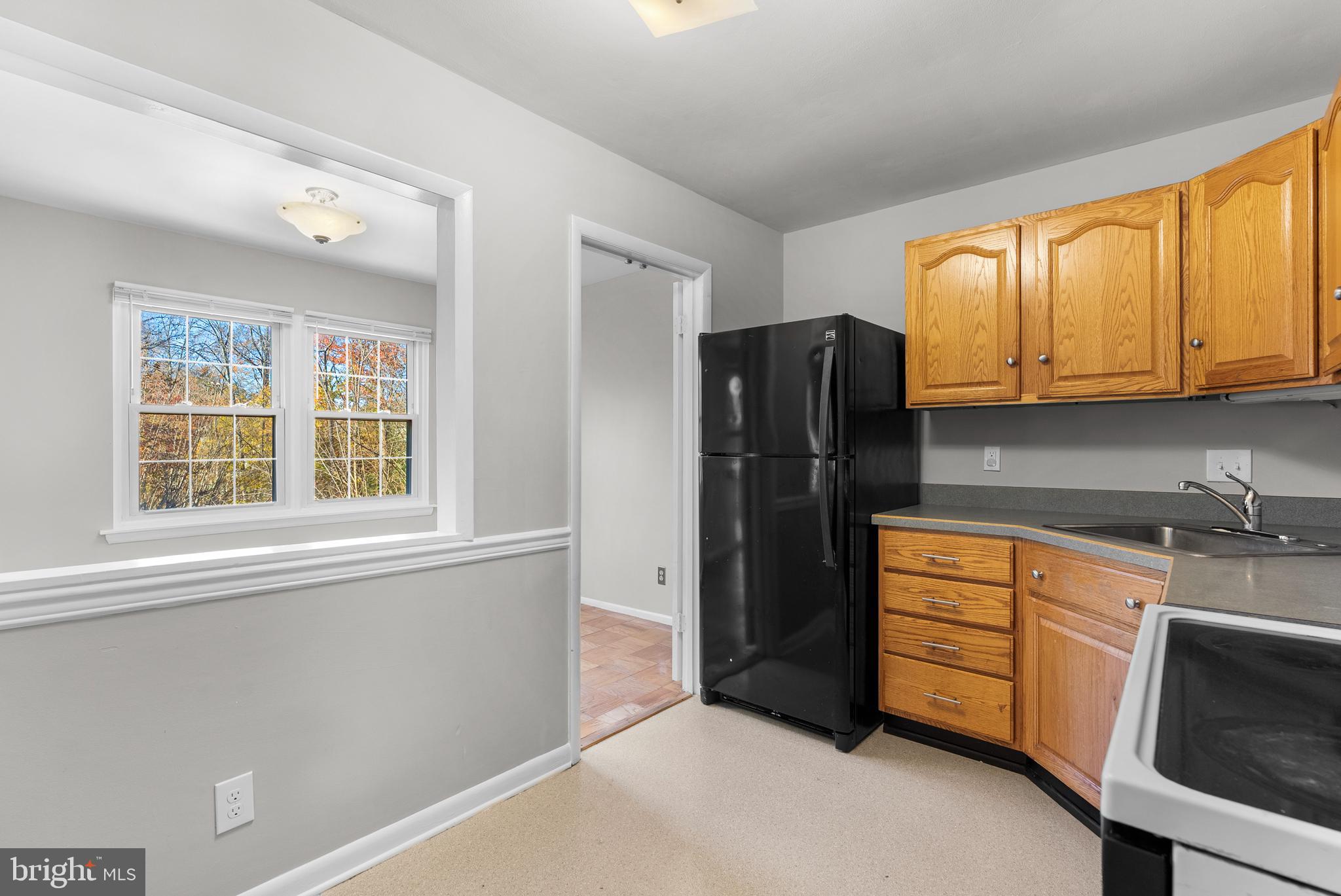 240 Crocker Drive, Unit 240F Bel Air, MD 21014 - Photo 13 of 38 a kitchen with stainless steel appliances granite countertop a refrigerator and a sink