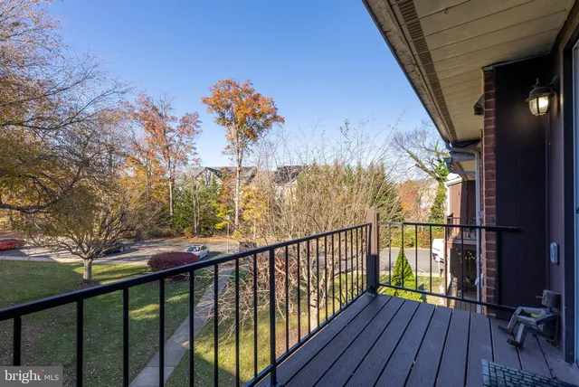 a view of balcony with wooden floor and seating space