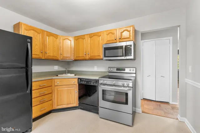 a kitchen with stainless steel appliances granite countertop a stove microwave and refrigerator