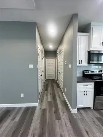a view of a kitchen with wooden floor