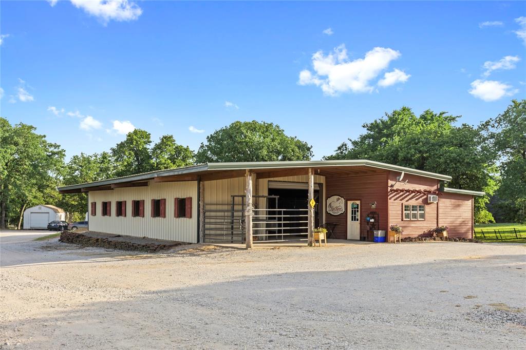 8016 Highway 82 Gainesville, TX 76240 - Photo 6 of 24 a front view of a house with a yard and garage