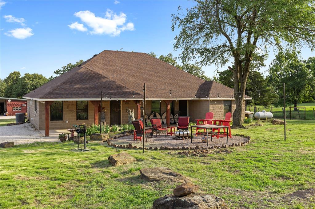 8016 Highway 82 Gainesville, TX 76240 - Photo 8 of 24 a front view of a house with garden and sitting area