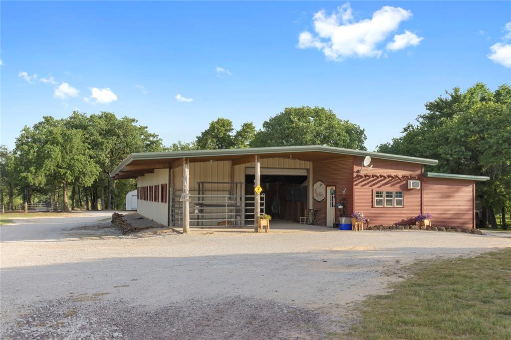 8016 Highway 82 Gainesville, TX 76240 - Photo 9 of 24 a view of a house with a yard and garage