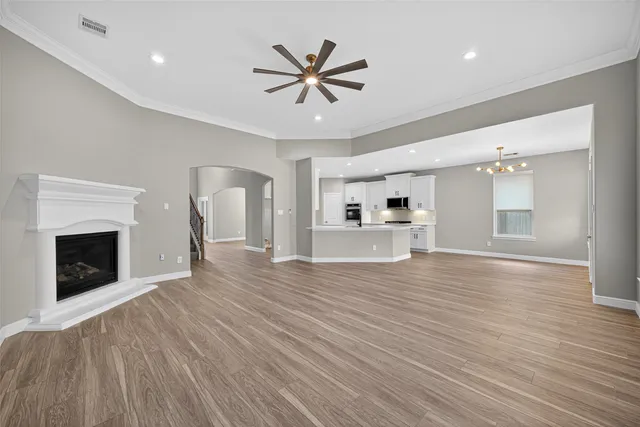 a view of empty room with wooden floor and fireplace