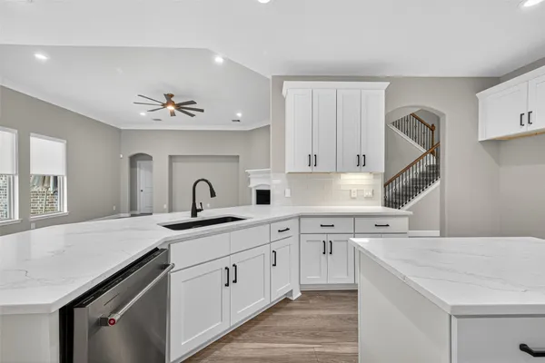 a kitchen with a sink cabinets and window