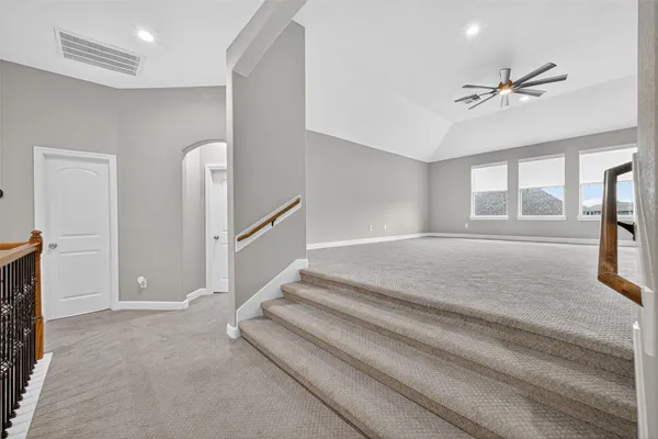 a view of a livingroom with a ceiling fan and window