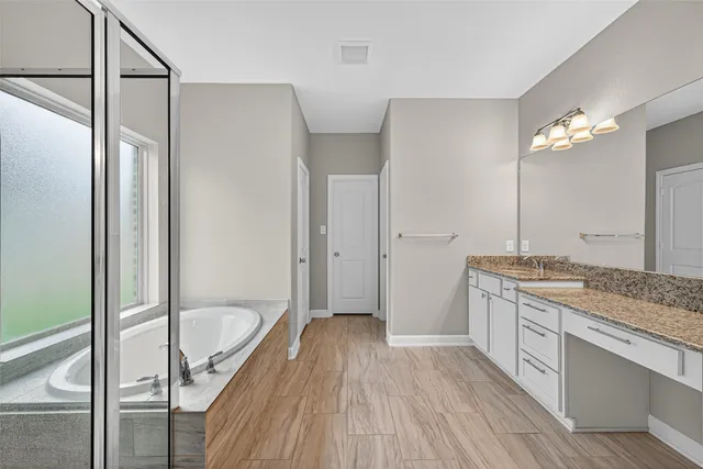 a bathroom with a sink a vanity a mirror and a toilet