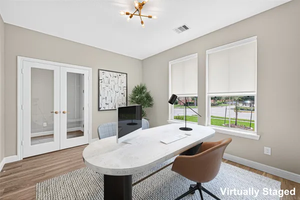 a view of a dining room with furniture window and wooden floor