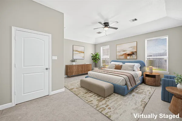 a spacious bedroom with a bed and a chandelier