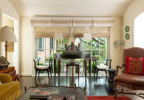 a view of a livingroom with furniture and floor to ceiling window