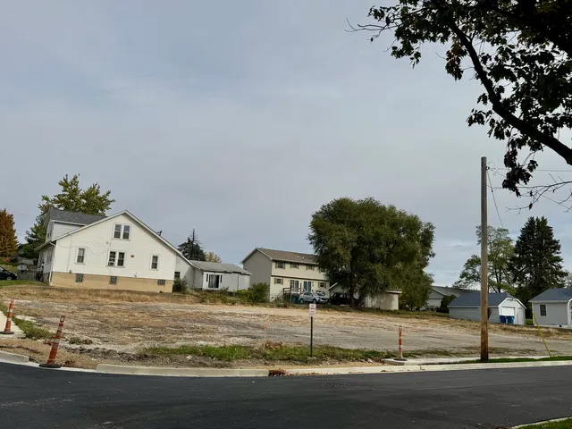 a view of a house with a yard and tree s