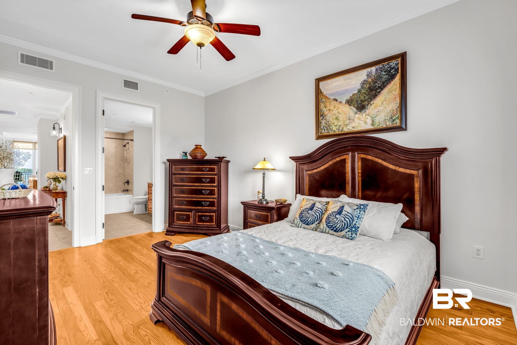 14500 River Road, Unit 305 Pensacola, FL 32507 - Photo 26 of 42 Hardwood flooring throughout the room, ceiling fan with integrated lighting, crown molding, and an attached full bathroom featuring a tub and shower combination