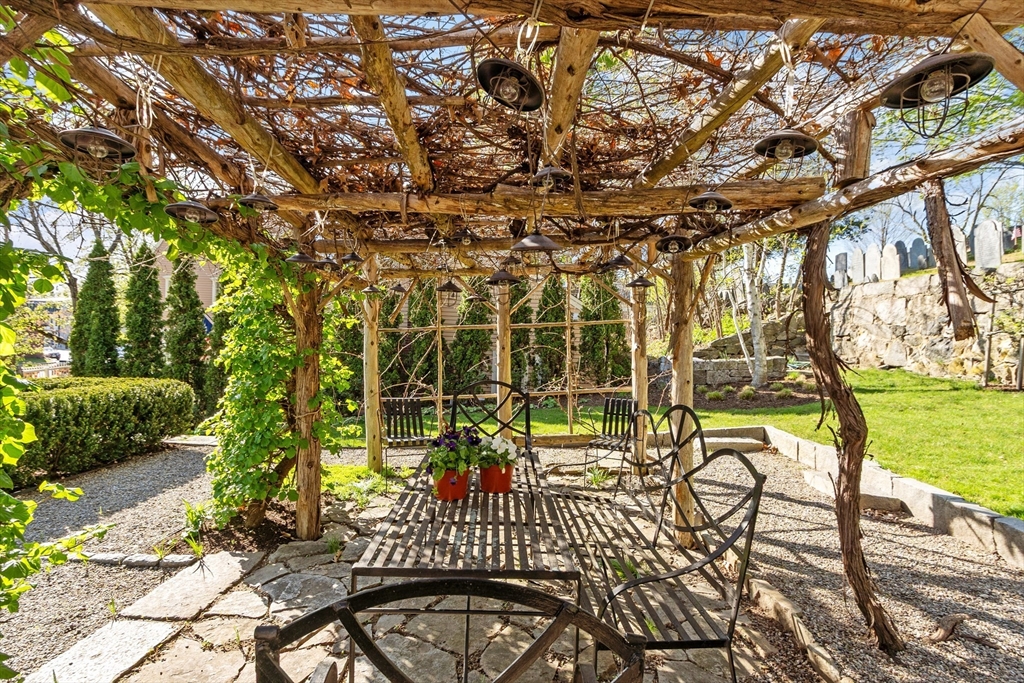 23 Lexington Road Concord, MA 01742 - Photo 4 of 42 a view of a patio with table and chairs and potted plants