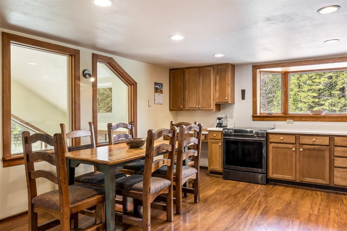 5115 Montezuma Road Montezuma, CO 80435 - Photo 12 of 35 a kitchen with granite countertop a stove dining table chairs and granite counter tops