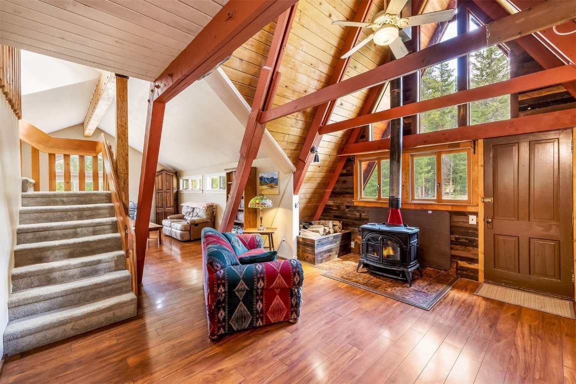 5115 Montezuma Road Montezuma, CO 80435 - Photo 22 of 35 a living room with furniture a fireplace and large windows