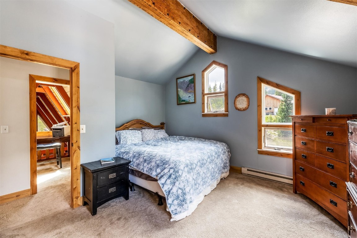 5115 Montezuma Road Montezuma, CO 80435 - Photo 25 of 35 a bedroom with a bed and a dresser next to a window