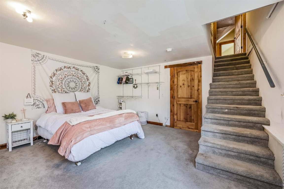 5115 Montezuma Road Montezuma, CO 80435 - Photo 29 of 35 a spacious bedroom with a bed and a walk in closet