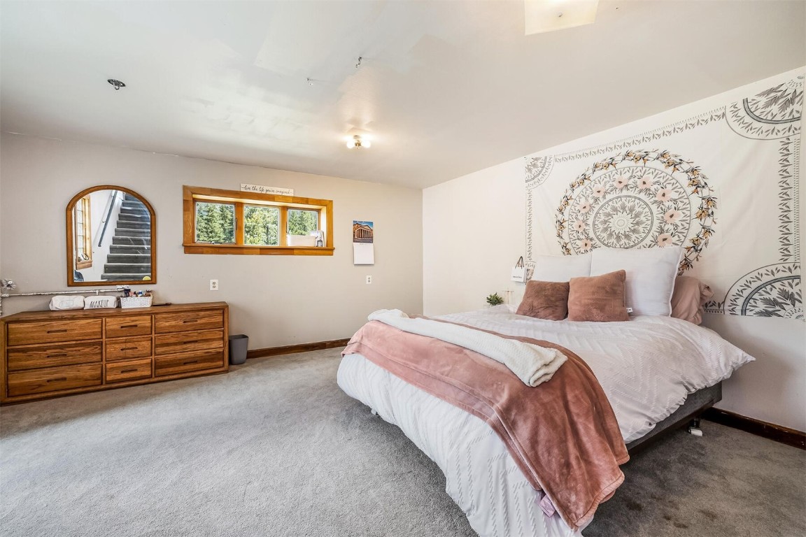 5115 Montezuma Road Montezuma, CO 80435 - Photo 30 of 35 a bed room with a bed and a dresser