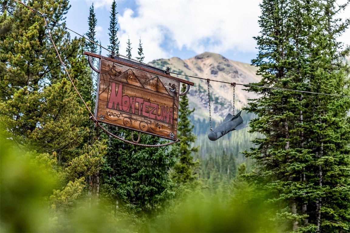 5115 Montezuma Road Montezuma, CO 80435 - Photo 4 of 35 a sign that is sitting on a brick wall