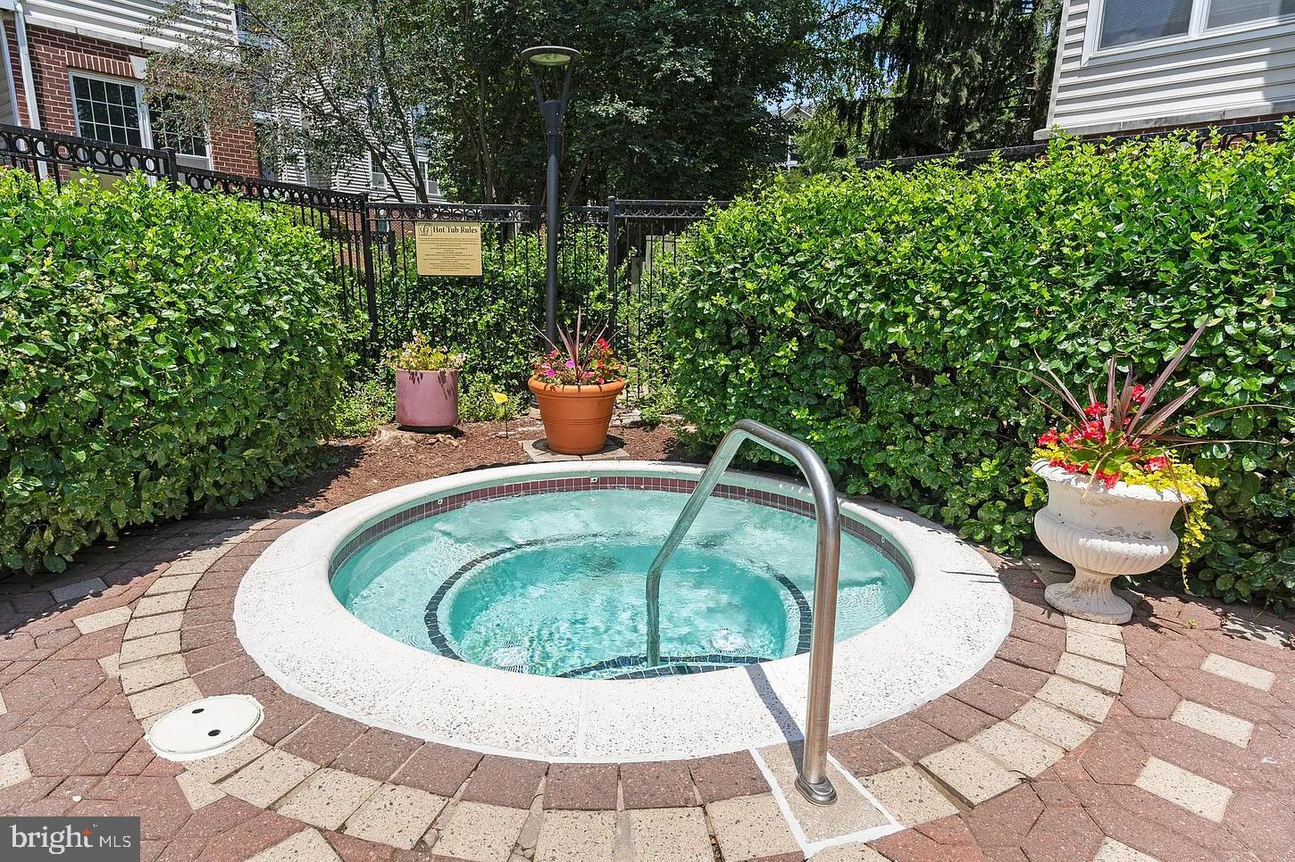 1581 Spring Gate Dr., Unit 5403 McLean, VA 22102 - Photo 15 of 20 a view of a swimming pool with a patio