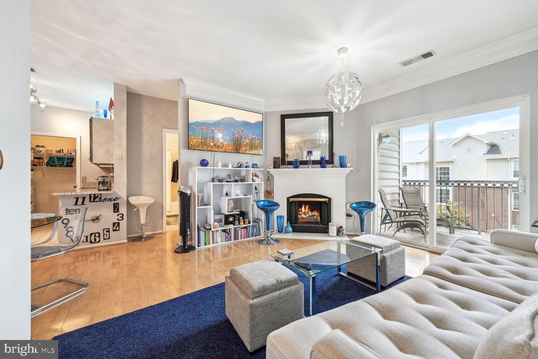 1581 Spring Gate Dr., Unit 5403 McLean, VA 22102 - Photo 2 of 20 a living room with furniture a fireplace and a large window