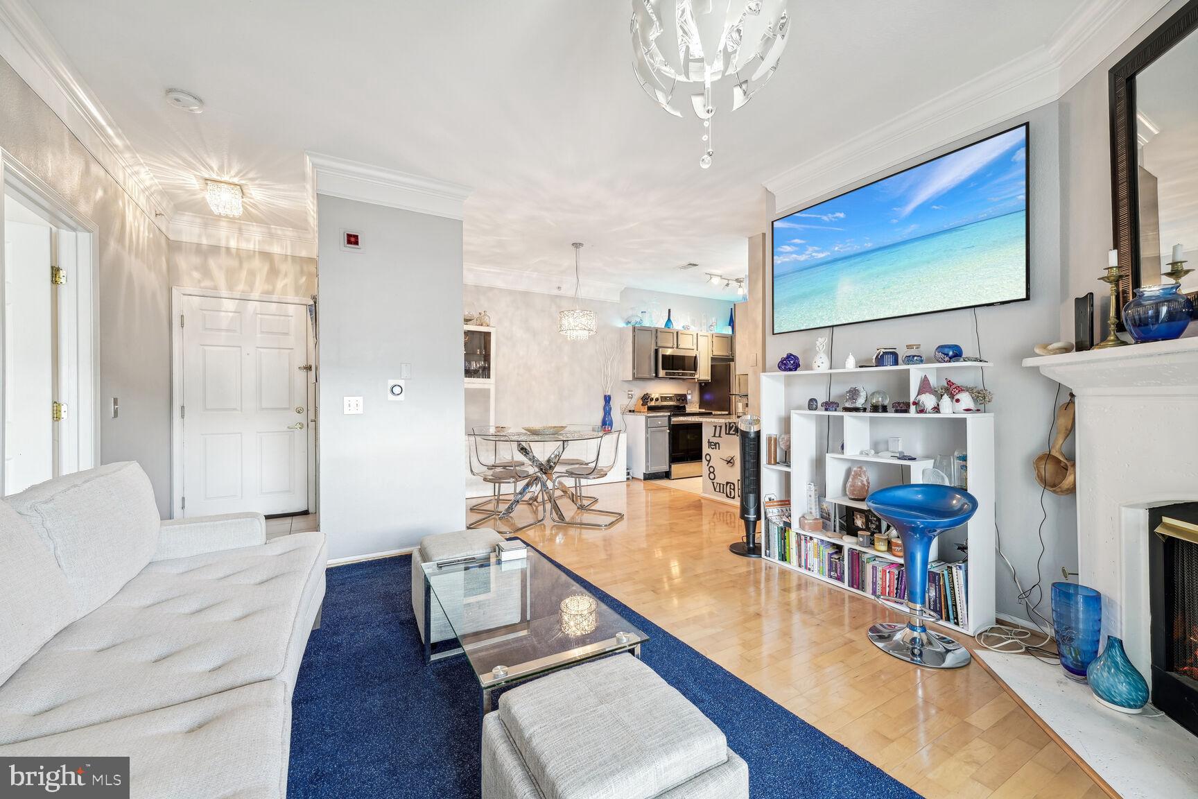 1581 Spring Gate Dr., Unit 5403 McLean, VA 22102 - Photo 3 of 20 a living room with furniture and a flat screen tv