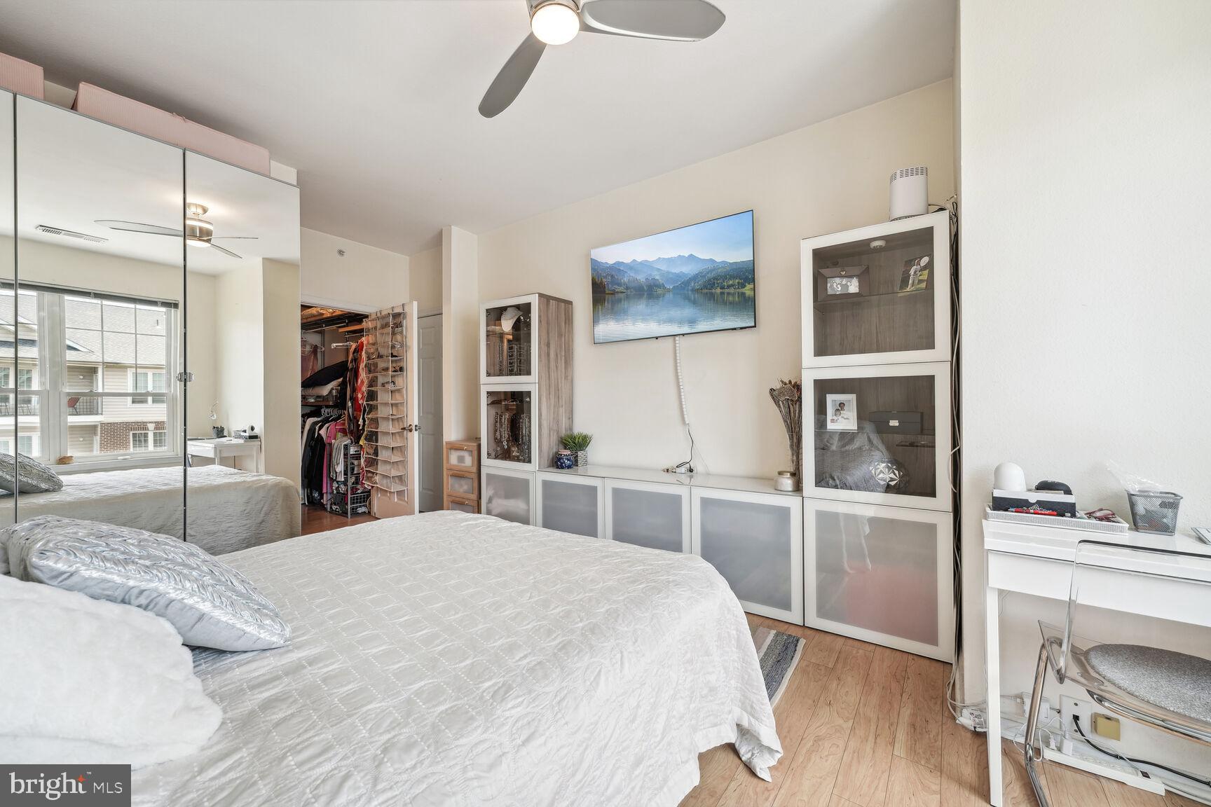 1581 Spring Gate Dr., Unit 5403 McLean, VA 22102 - Photo 7 of 20 a bedroom with a bed and a large mirror