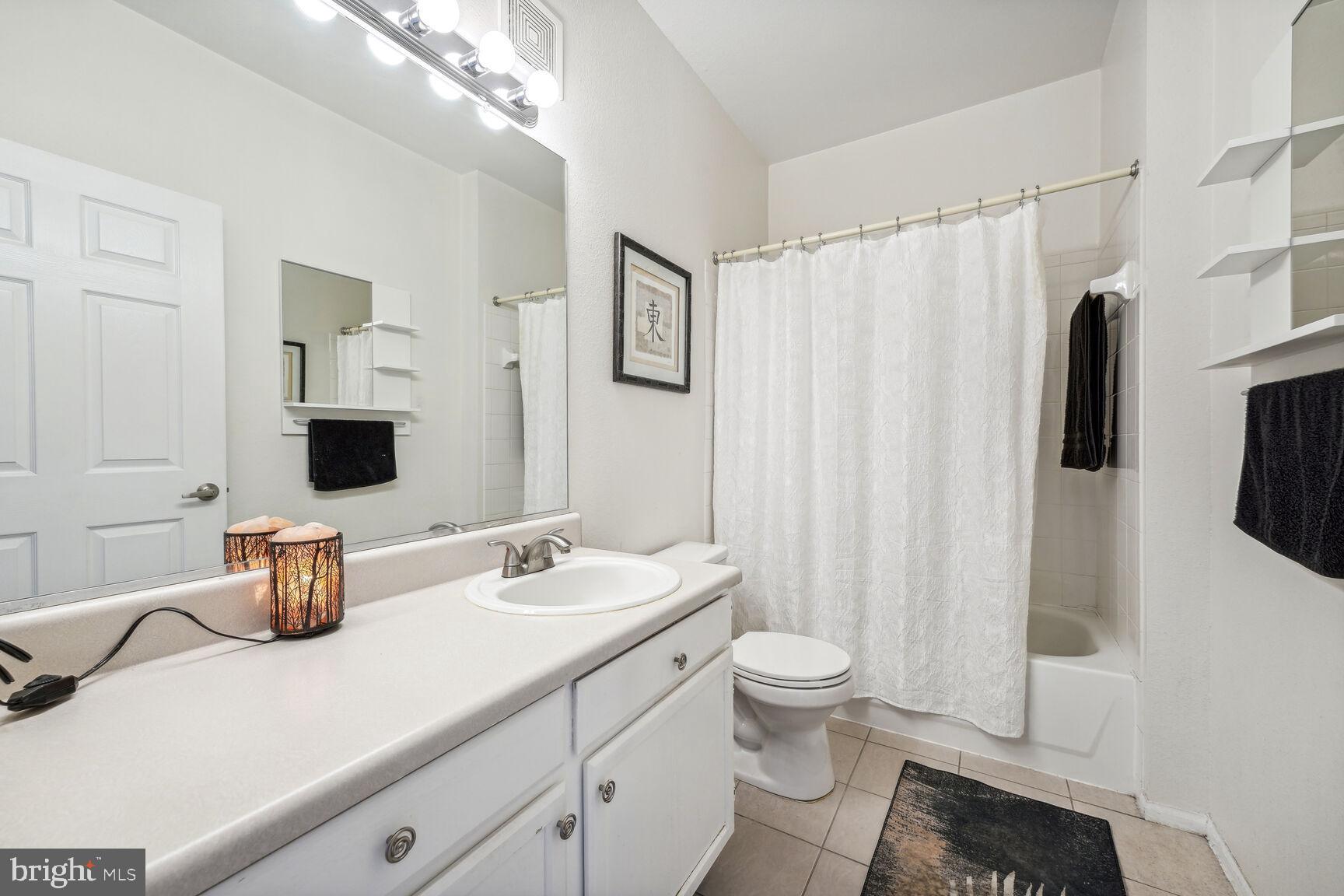 1581 Spring Gate Dr., Unit 5403 McLean, VA 22102 - Photo 8 of 20 a bathroom with a double vanity sink toilet and shower