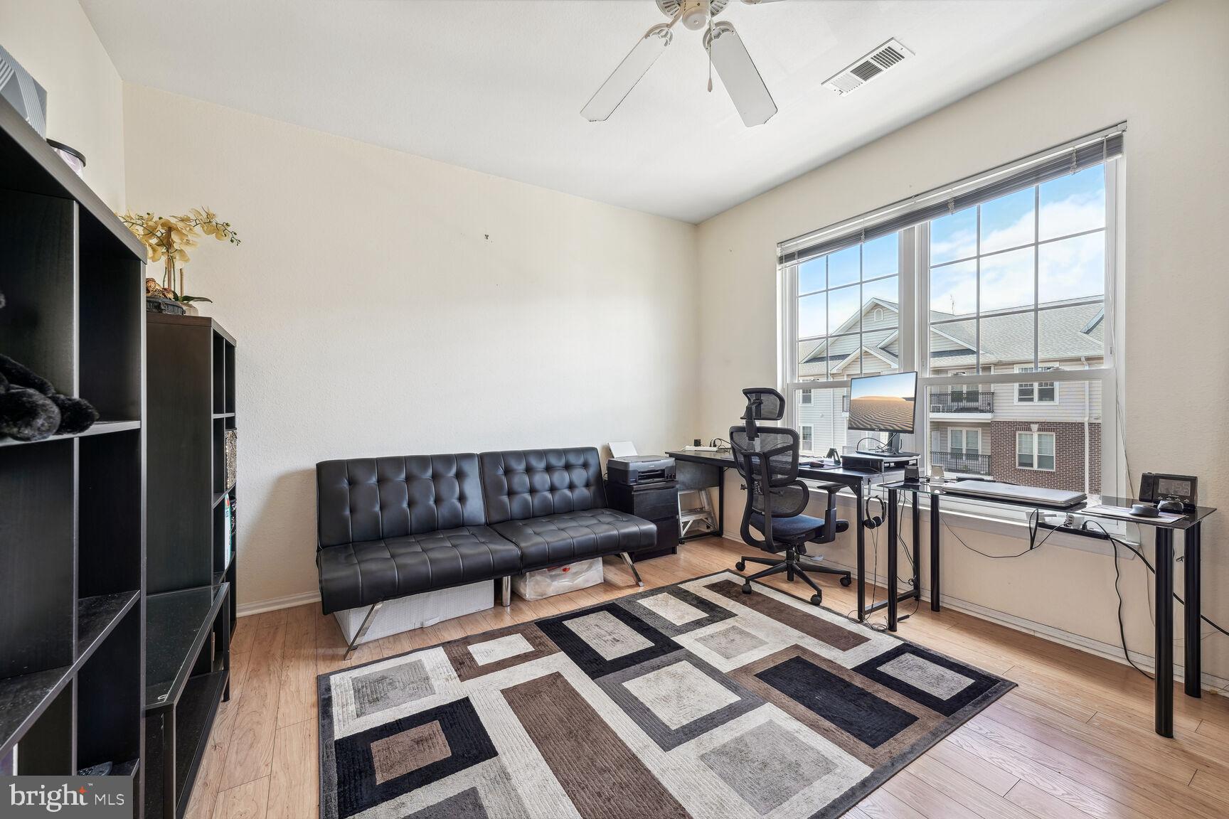 1581 Spring Gate Dr., Unit 5403 McLean, VA 22102 - Photo 9 of 20 a living room with furniture a flat screen tv and a table