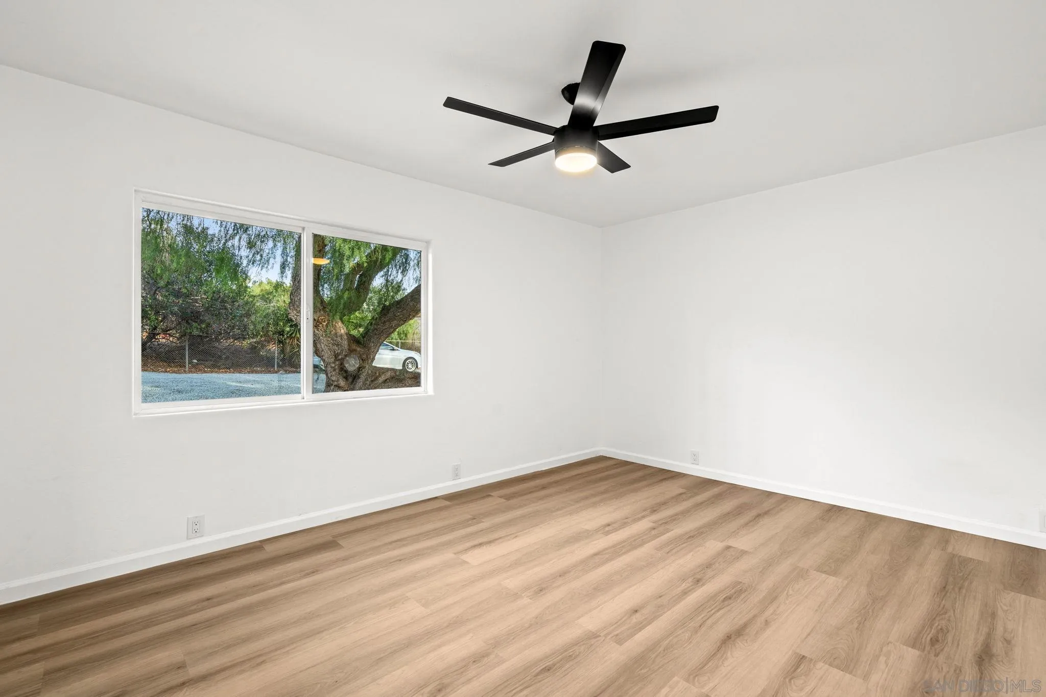 3110 Rio Madre Lane Jamul, CA 91935 - Photo 24 of 48 a view of empty room with wooden floor and fan