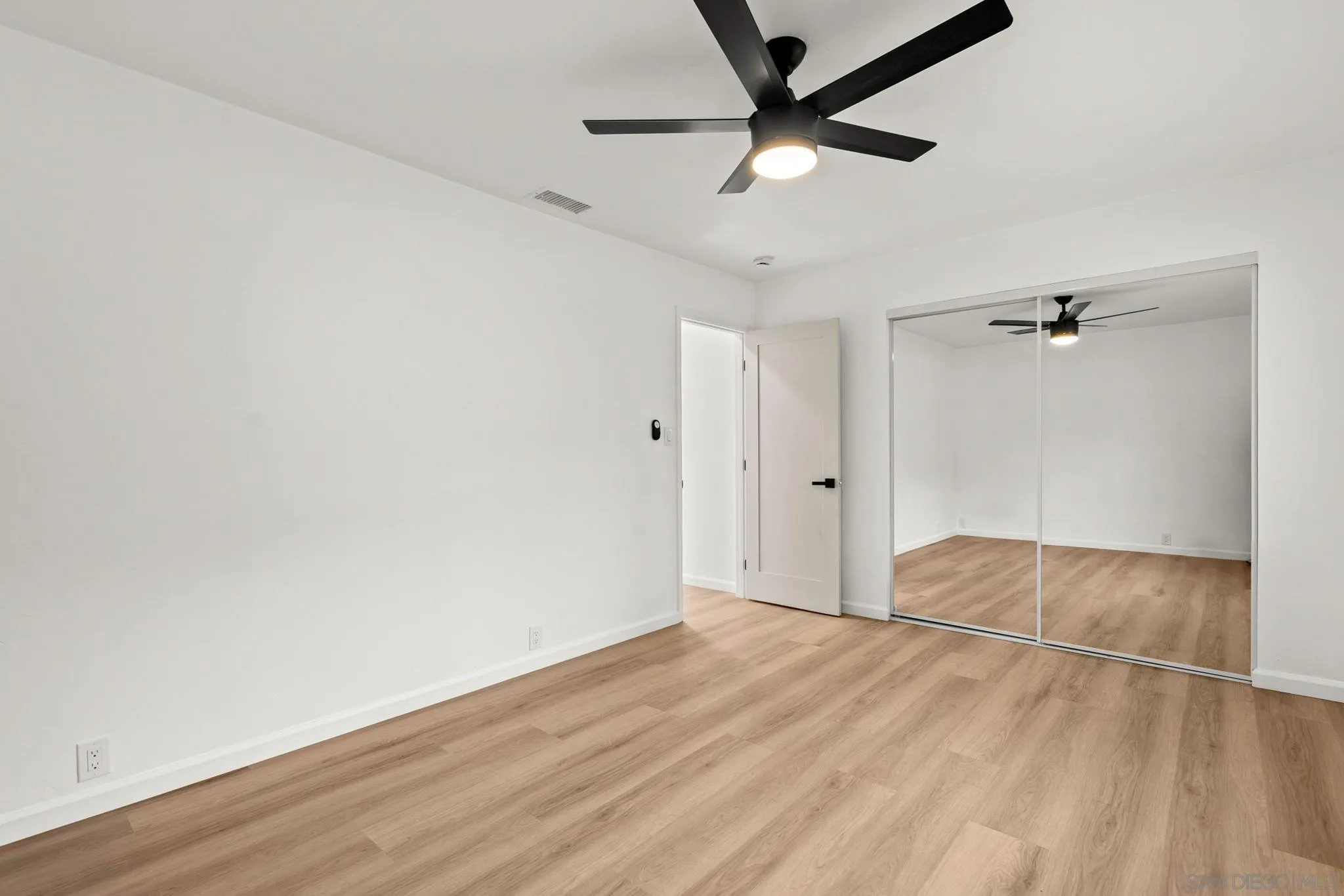 3110 Rio Madre Lane Jamul, CA 91935 - Photo 26 of 48 an empty room with wooden floor fan and windows