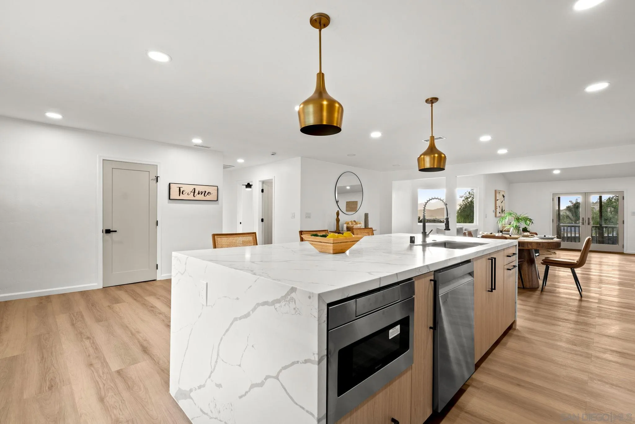 3110 Rio Madre Lane Jamul, CA 91935 - Photo 5 of 48 a kitchen with stainless steel appliances granite countertop a sink a stove and wooden floor