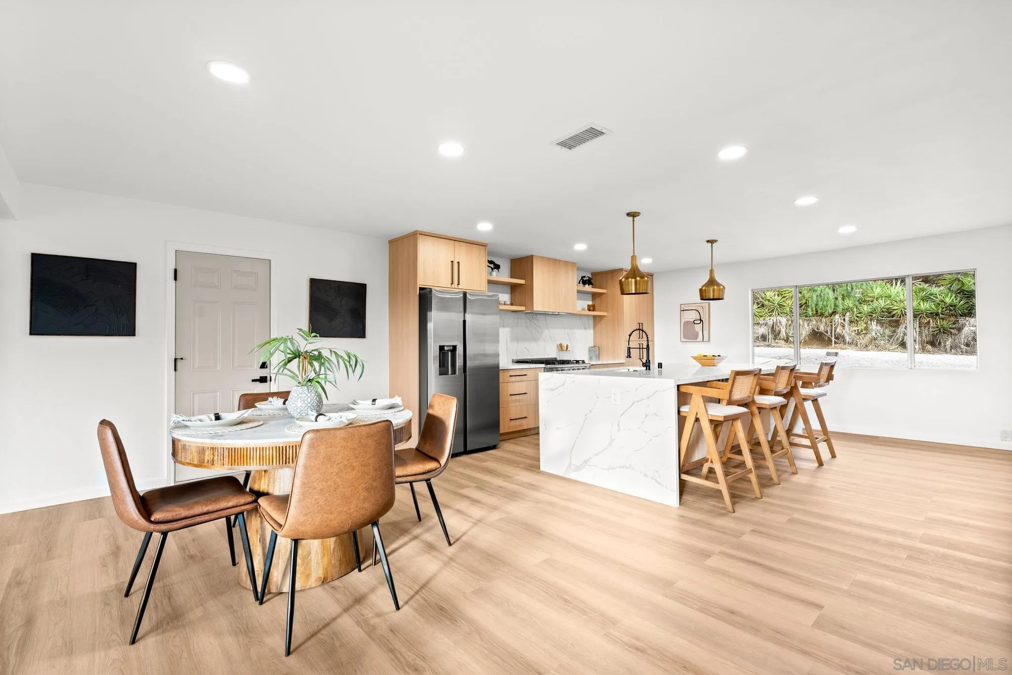 3110 Rio Madre Lane Jamul, CA 91935 - Photo 7 of 48 a dining room with stainless steel appliances kitchen island granite countertop a dining table chairs and a refrigerator