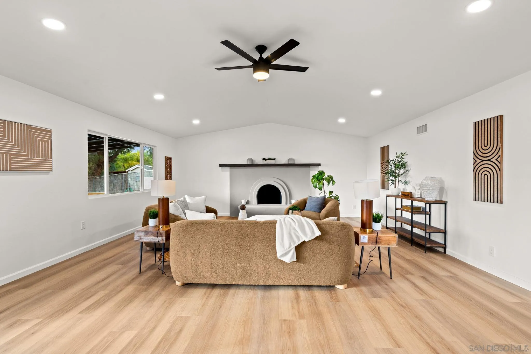 3110 Rio Madre Lane Jamul, CA 91935 - Photo 10 of 48 a living room with furniture a fireplace and a ceiling fan