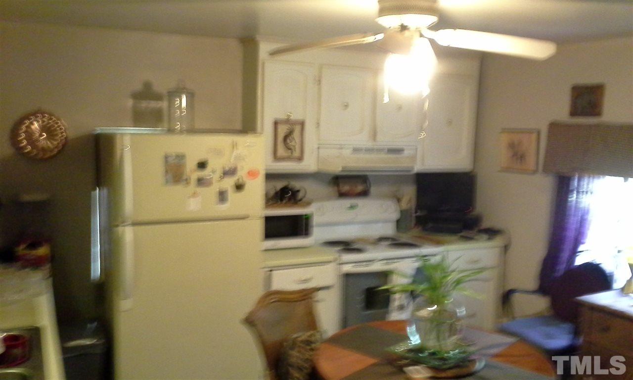 10743 Old Stage Road Raleigh, NC 27603 - Photo 6 of 6 a kitchen with stainless steel appliances granite countertop a sink a stove and a refrigerator