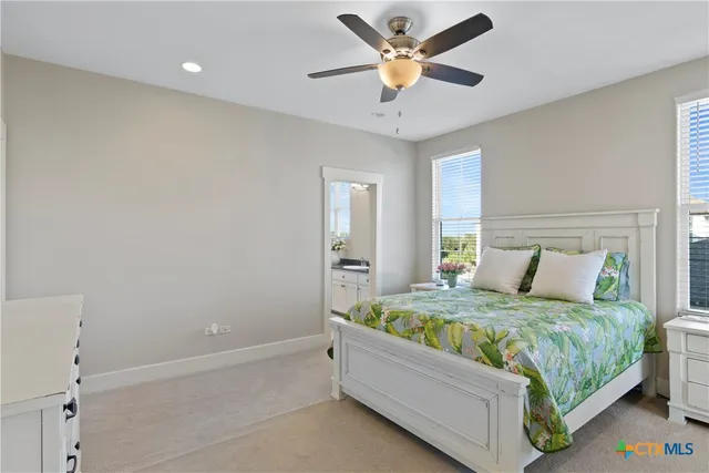 a bedroom with a bed and a ceiling fan