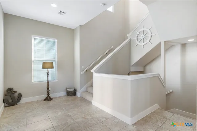 a bathroom with a granite countertop bathtub sink vanity mirror and toilet