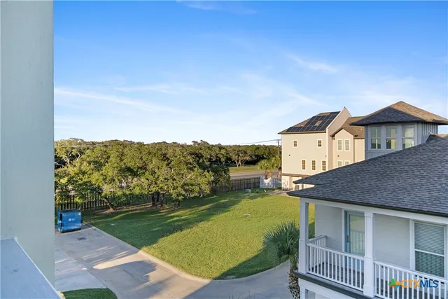 a view of backyard with swimming pool and outdoor seating