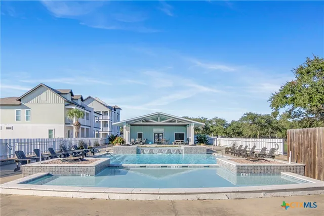 a view of a patio with table and chairs with wooden floor and fence