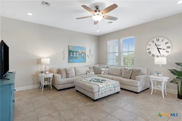 a living room with furniture a bed and a flat screen tv