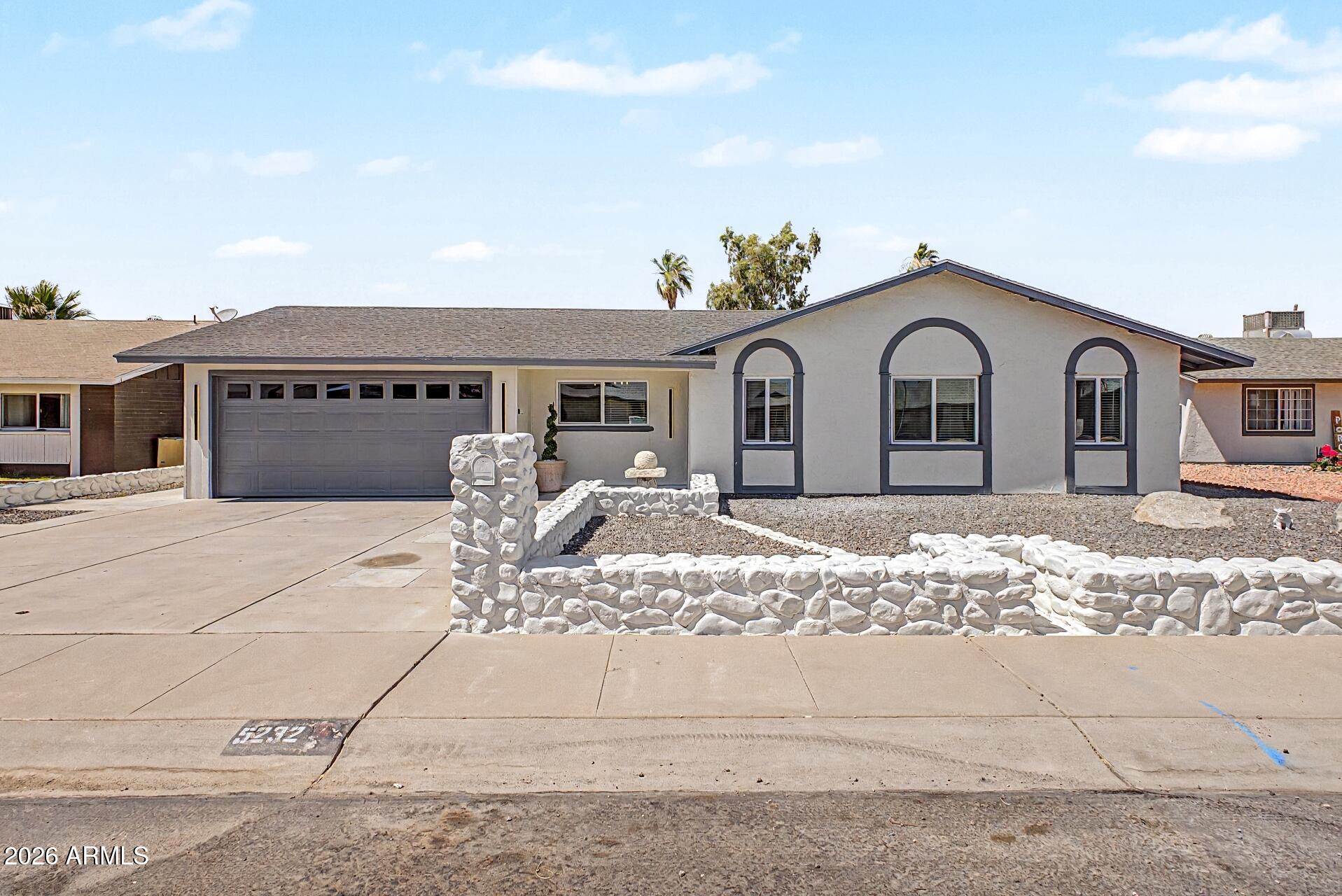 5232 West Hearn Road Glendale, AZ 85306 - Photo 5 of 32 a front view of a house with a yard