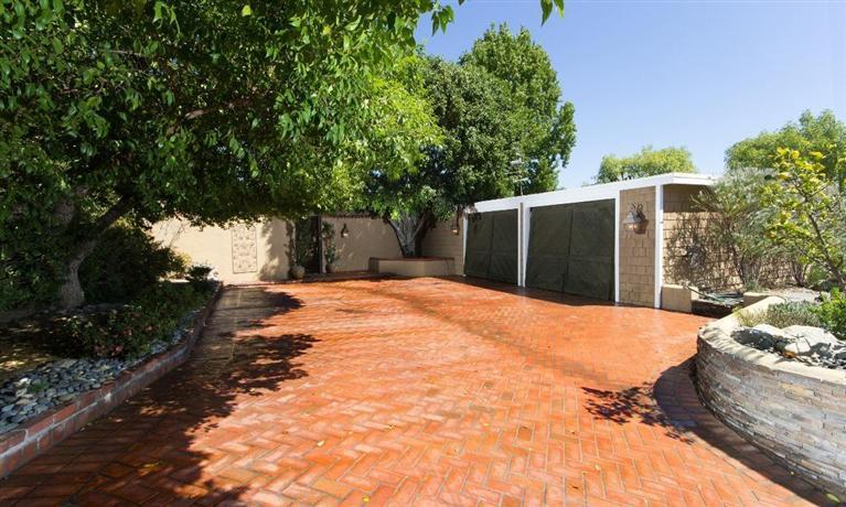 a backyard of a house with a yard and garage