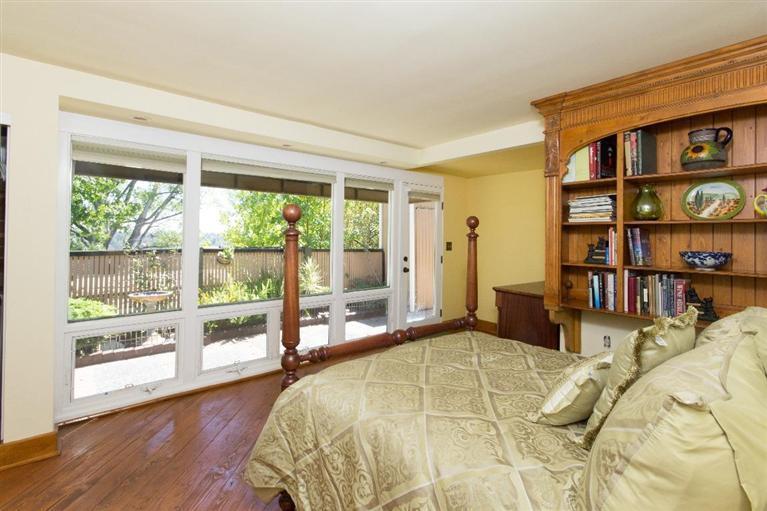 1131 Heatherside Road Pasadena, CA 91105 - Photo 20 of 44 a bed sitting in a bedroom next to a book shelf