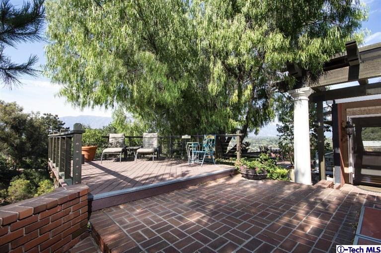 1131 Heatherside Road Pasadena, CA 91105 - Photo 42 of 44 a view of a patio with table and chairs and potted plants
