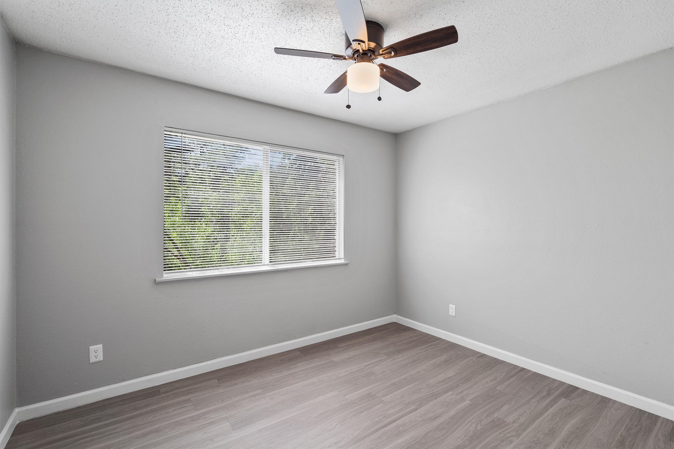 2501 Manor Circle, Unit B Austin, TX 78723 - Photo 12 of 17 an empty room with wooden floor and windows