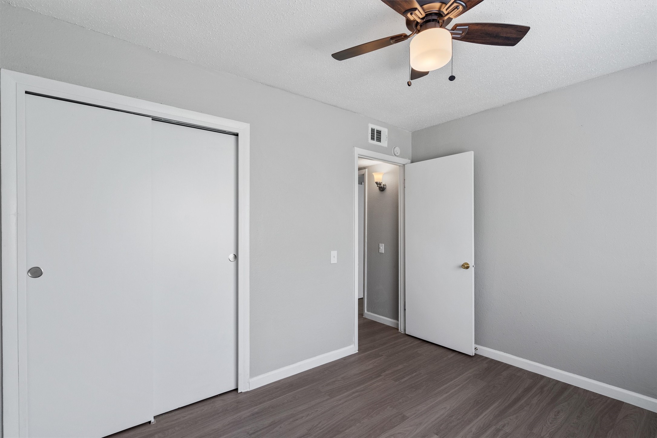 2501 Manor Circle, Unit B Austin, TX 78723 - Photo 13 of 17 a view of an empty room with wooden floor